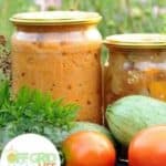 Jars of tomatoes and cucumbers on a table.