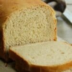A loaf of bread is sitting on a cutting board.