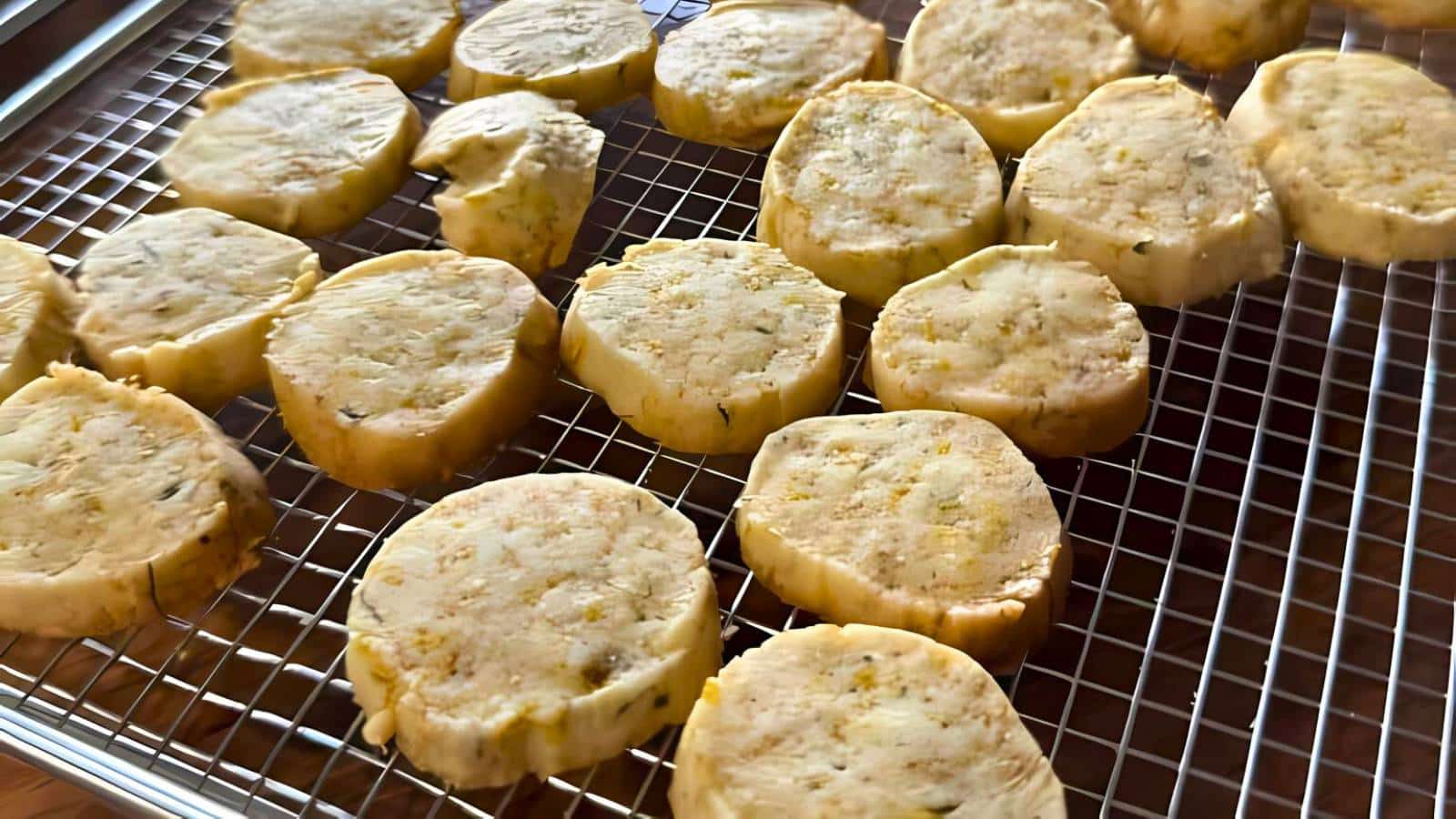 Slices of raw cookie dough placed on a cooling rack.