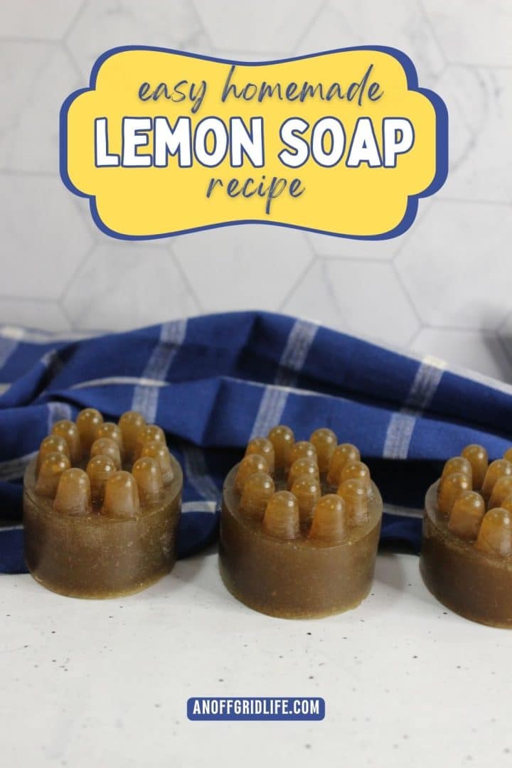 Three round homemade lemon soaps with massage bumps sit on a white surface in front of a blue checkered cloth; text above reads "easy homemade lemon soap recipe.