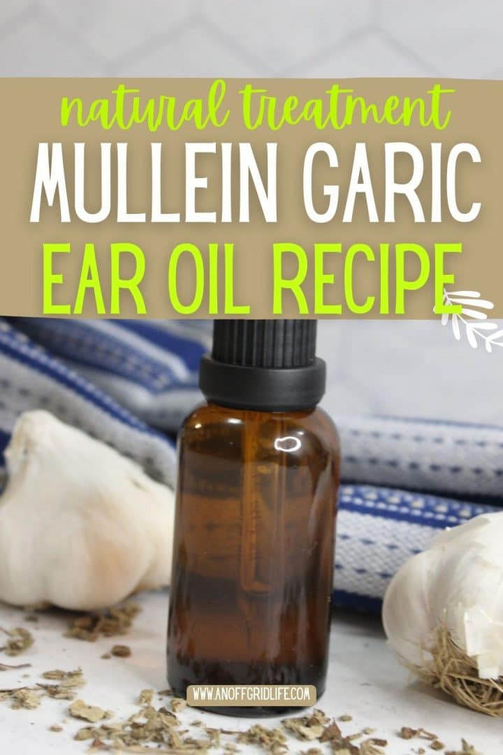A small brown dropper bottle sits on a counter with garlic bulbs, herbs, and a blue-striped towel; text reads "Natural Treatment Mullein Garlic Ear Oil Recipe.