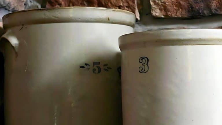 Two large ceramic containers with numbers "5" and "3" are placed side by side against a brick wall.