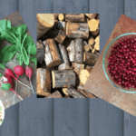 homegrown vegetables, handcut firewood, foraged cranberries on a wooden background