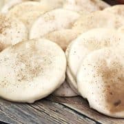 A plate of frosted cookies sprinkled with cinnamon.