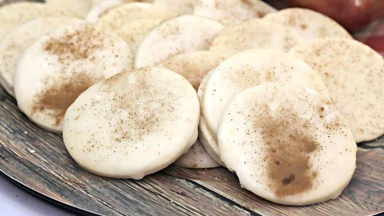 A plate of frosted cookies sprinkled with cinnamon.