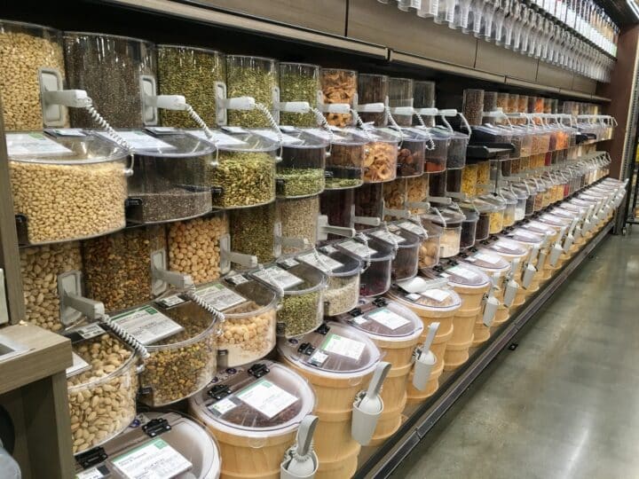 A row of containers filled with different kinds of seeds.