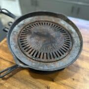 A cast iron skillet on top of a wooden table.