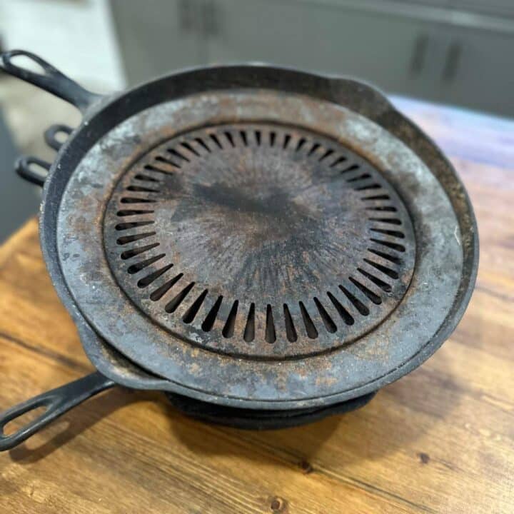 A cast iron skillet on top of a wooden table.