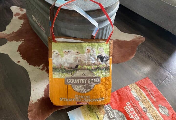 A bag of chicken feed on a wooden floor.