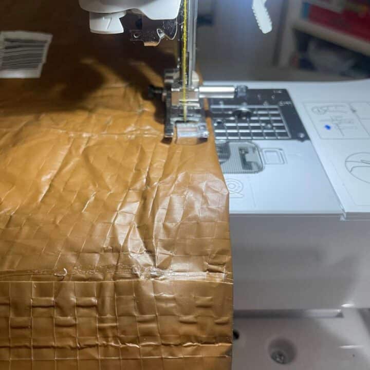 A sewing machine with a brown bag on it.