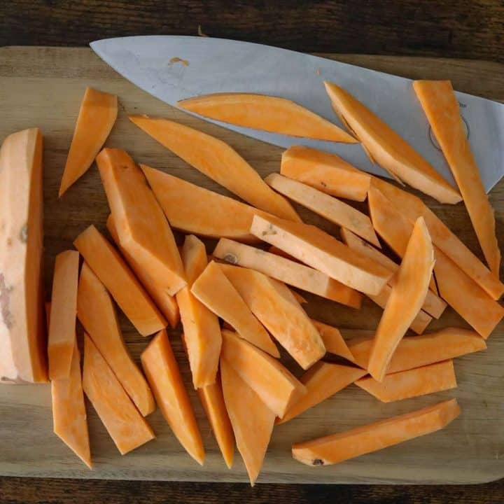Sliced squash on a cutting board with a knife.