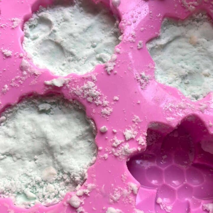 A pink soap mold with aromatherapy shower steamer mixture in it.