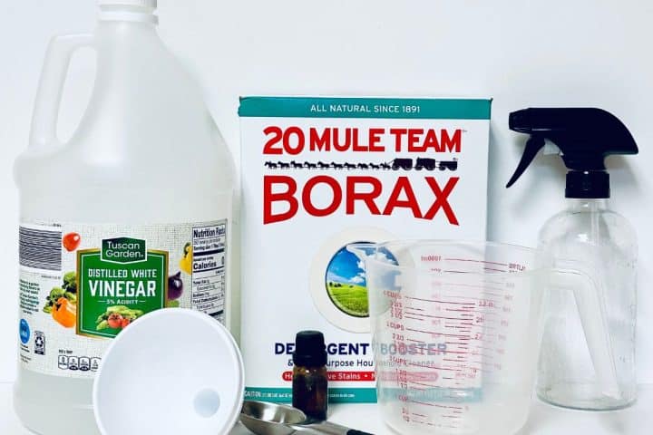 Borax, vinegar, essential oils and ingredients to make DIY magic eraser liquid.