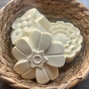 White flower soap in a wicker basket.