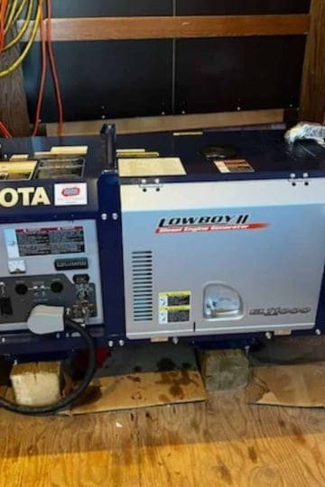 a picture of a blue Kubota generator in a generator shed