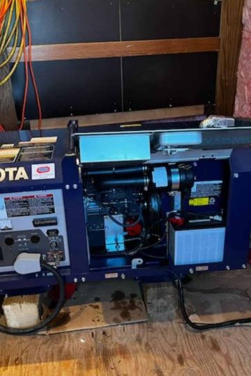 a picture of a blue kubota generator in a generator shed