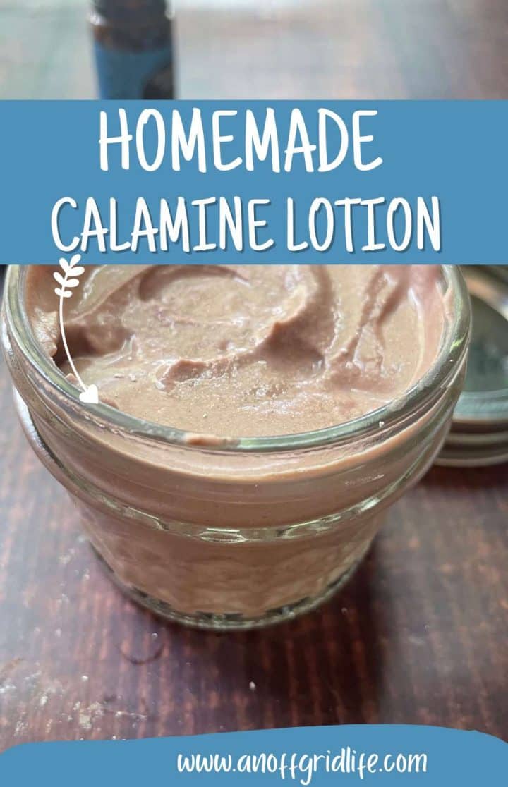 A glass jar of homemade calamine lotion on a wooden table with the label "homemade calamine lotion" and a website address.