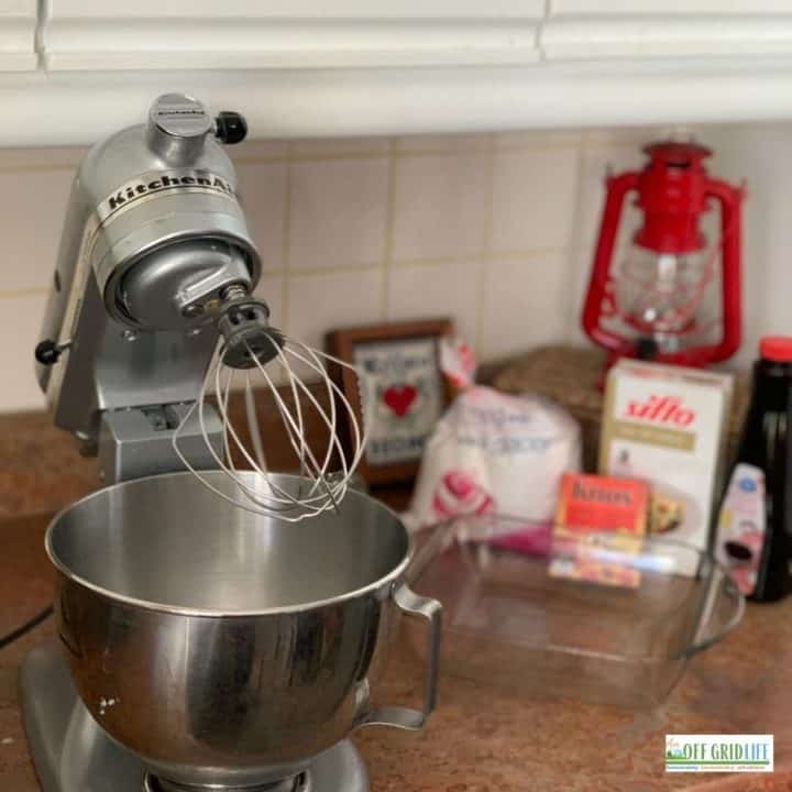 a kitchenaid stand mixer on a countertop next to other homestead essential tools