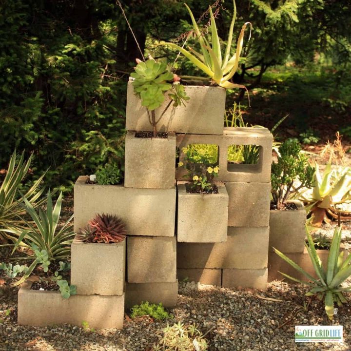 a cinder block garden stacked four blocks high, with plants in each block.