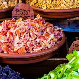 wooden bowls of dehydrated fruits, including papaya and pomelo