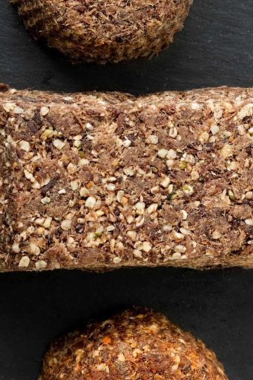 A picture of 3 pieces of pemmican made with game meat and a black background.