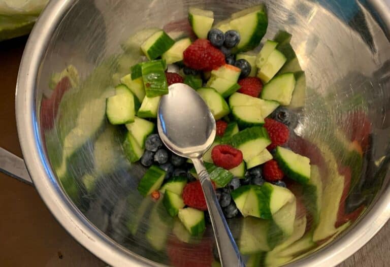 Making cucumber berry fruit salsa.