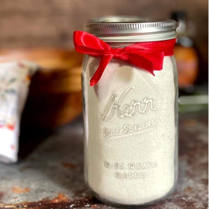 A mason jar filled with homemade pancake mix and a red ribbon.