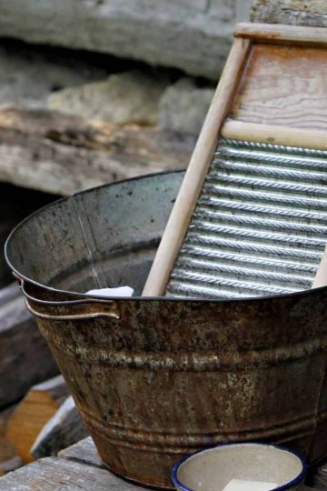 a picture of a washboard in a steel basin outdoors