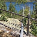 Our diy off grid water supply system above ground pipe going over rock down to the lake