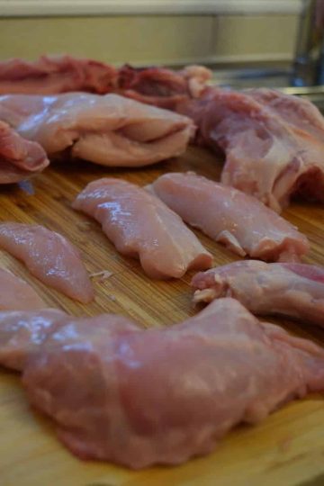 a picture of a fully butchered rabbit on a wooden cutting board