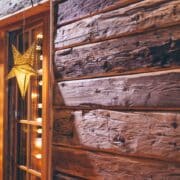 A rustic Christmas decor idea; a wooden window frame with a star hanging from it.