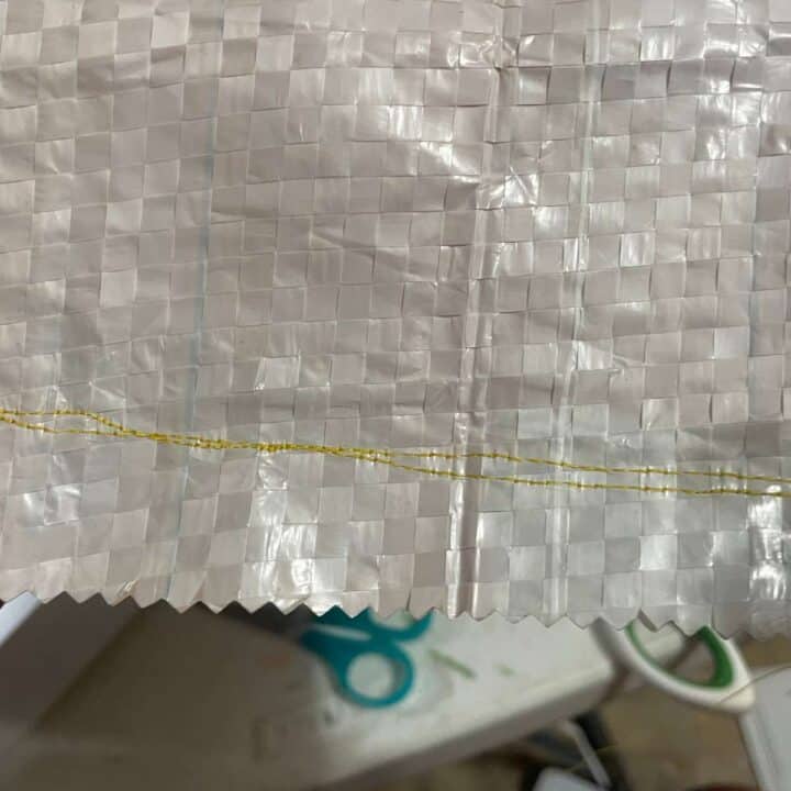 A piece of fabric with a yellow thread on it.
