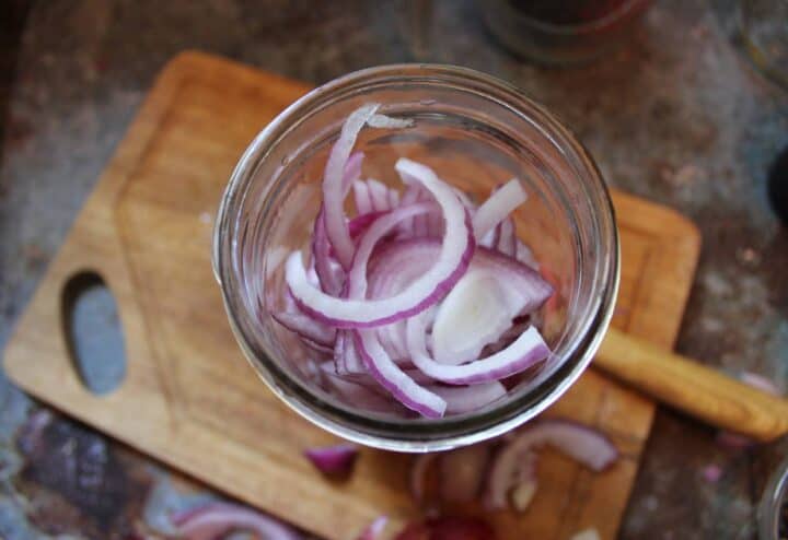 Sliced red onions in mason jar