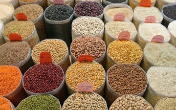 Dried goods in pails at a market.