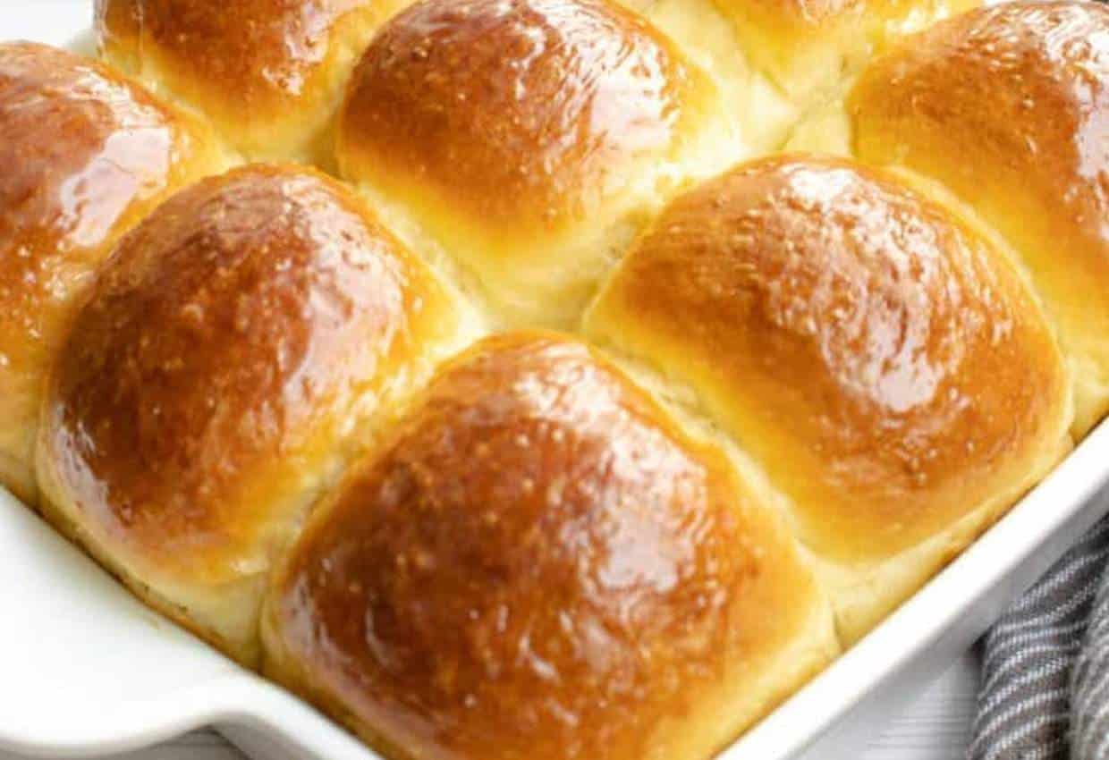 Homemade sweet rolls with condensed milk in baking dish.