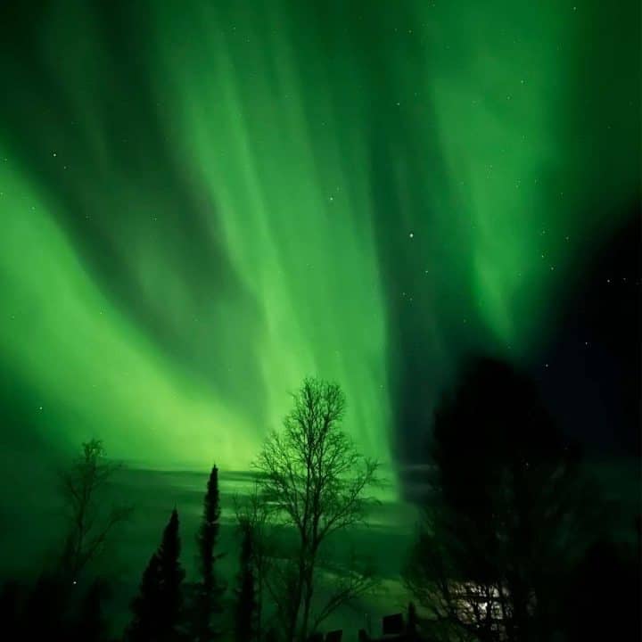 A green aurora bore lights up the sky over an  off the grid cabin in Canada's Northwest Territories.