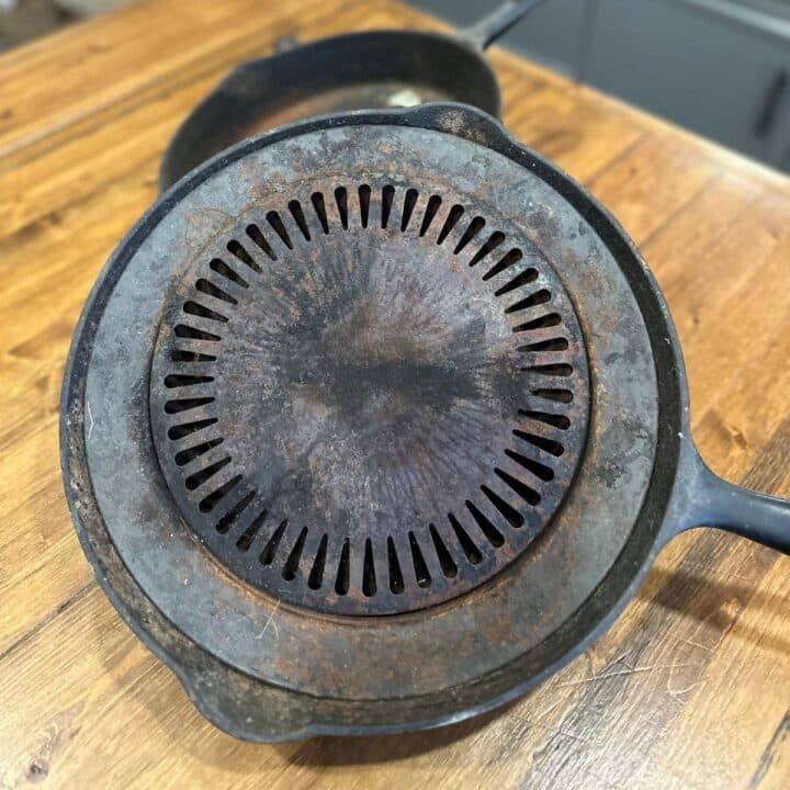 A cast iron skillet on top of a wooden table.