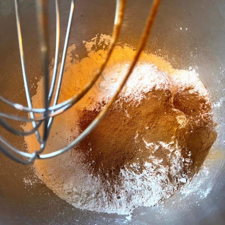A whisk is being used to mix the ingredients in a bowl.
