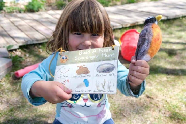 girl holding bird nest scavenger hunt printable