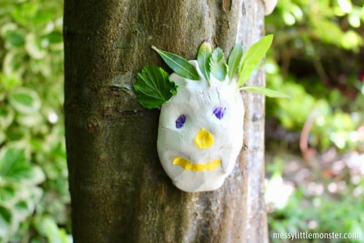 clay face on tree trunk