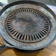 A cast iron griddle on a wooden table.