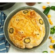 A tortilla with jalapenos and cheese on a plate.