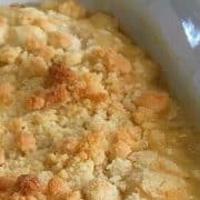 Close-up of apple crumble in a white baking dish.