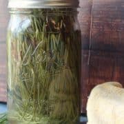 Pine needles in a mason jar next to a towel.