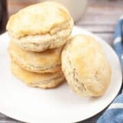 Sourdough Discard Biscuits stacked on plate with blue cloth napkin.