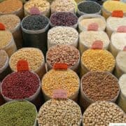 Dried goods in pails at a market.