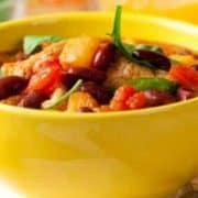A bowl of chili in a yellow bowl.