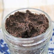 A jar of coffee granules on a blue and white plate.