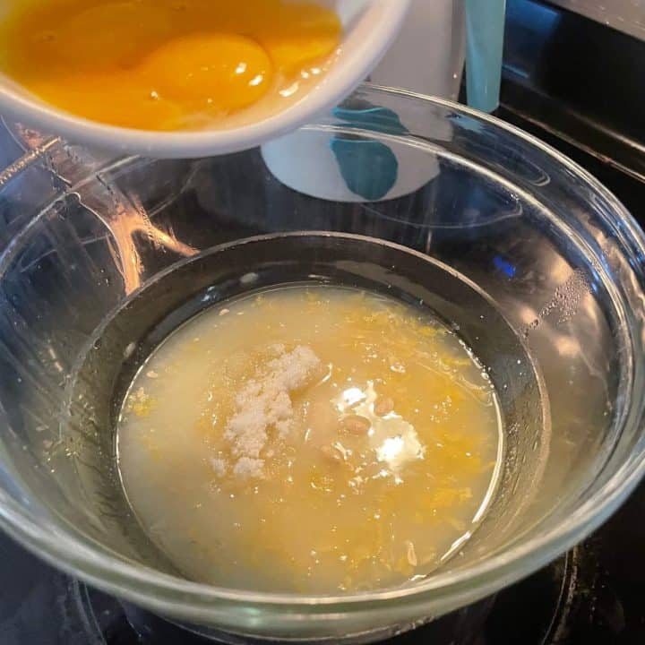 A bowl filled with eggs and lemon juice.