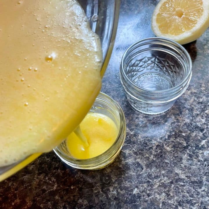 mixed of lemon juice and egg being poured into a glass.